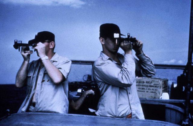 Measuring three-point sextant fix during launch hydrography. Picture