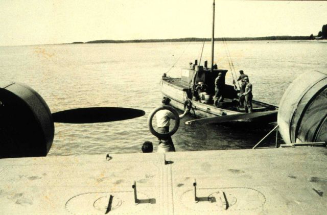 Coast Guard PBY hitching a tow after landing. Picture
