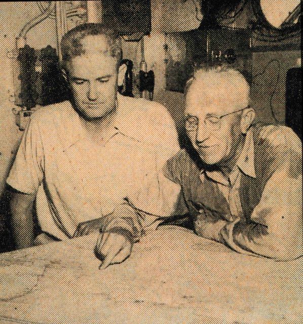 Captains George Anderson and Fred Peacock reviewing survey work on the Coast and Geodetic Survey Ship HYDROGRAPHER while operating in the Gulf of Mexi Picture