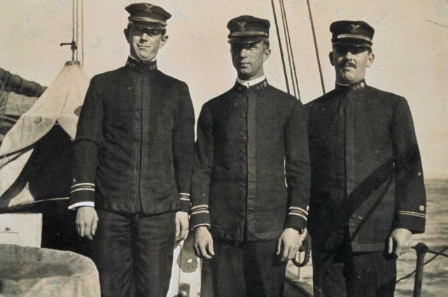 Three unidentified officers on a C&GS ship Picture