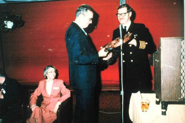 Caaptain Sig Peterson presenting Rear Admiral Harley Nygren with a carved NOAA Corps insignia upon the occasion of Admiral Nygren's retirement. Picture