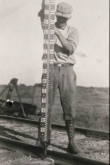 Rodman holding rod vertical during observations. Picture