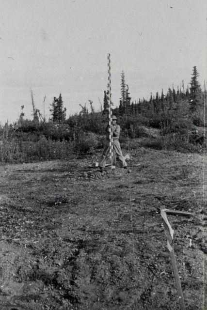 Rodman holding rod steady for observations Picture