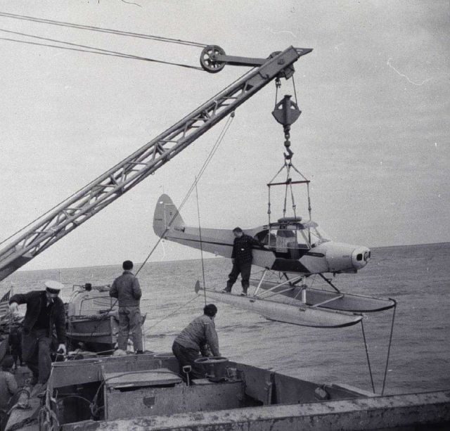 Loading a stripped down Piper Cub on the PIONEER Picture