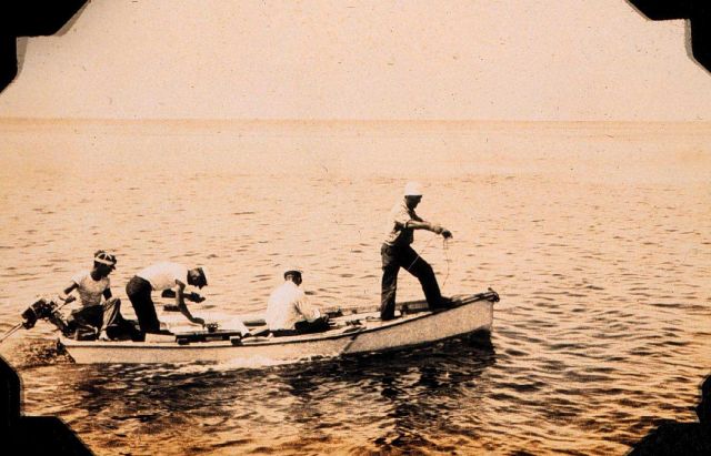 Skiff outfitted for hydrography - casting the lead Picture