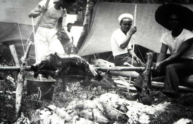 Camp cook roasts the boar and all hands get barbecued pork. Picture