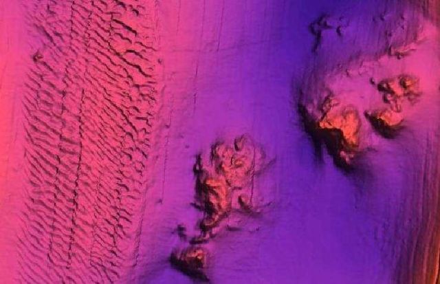 Rock outcrops adjacent to high current area of sand waves Picture