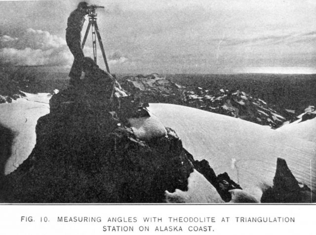 Measuring angles with theodolite at triangulation station on Alaska Coast Picture
