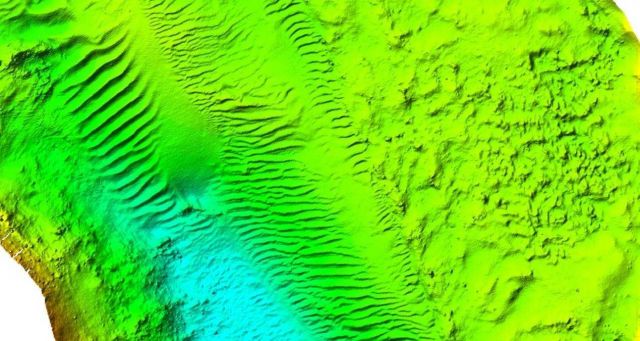 Unidentified 3-D view of bottom which includes rock outcrops and sandwaves Picture