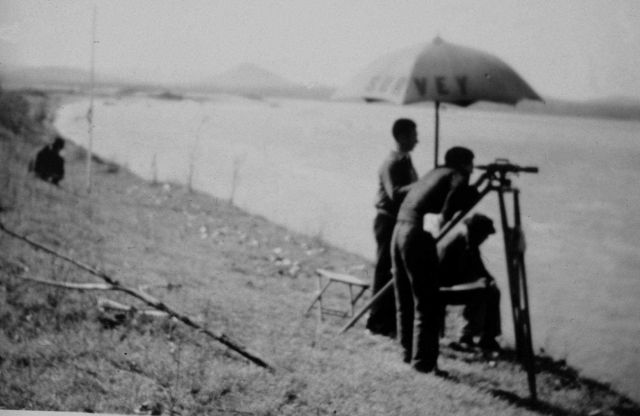 Leveling operations making an observation across water. Picture