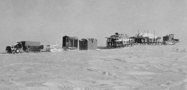 Caterpillar caravan heading to a new camp over the frozen Bering Sea in March. Picture