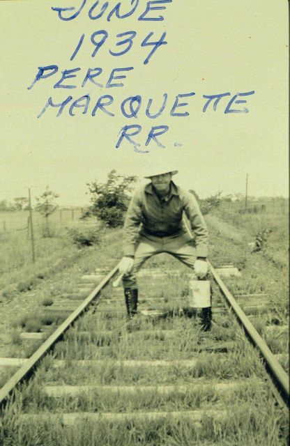 Ben Hickok painting arrows in center of tracks pointing to bench marks set off railroad, but still on the railroad right-of-way. Picture