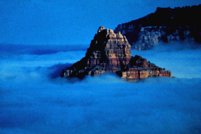 A rocky peak rises from a sea of fog in an Arizona valley Picture
