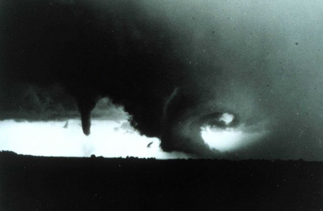 A swirling mass of clouds associated with tornado to left Picture