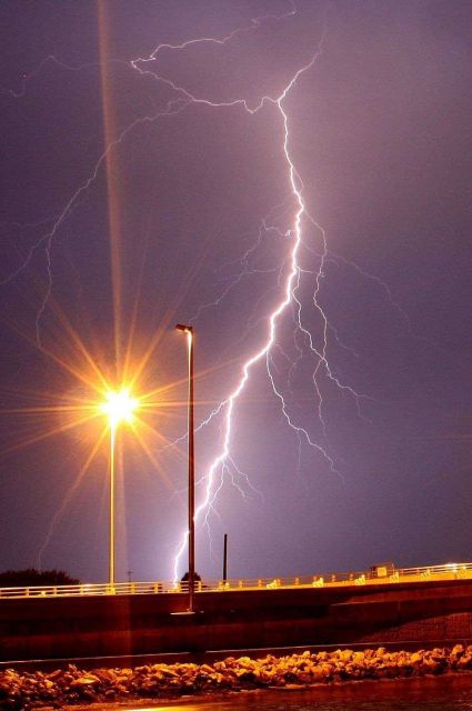 Lightning striking near bridge Picture