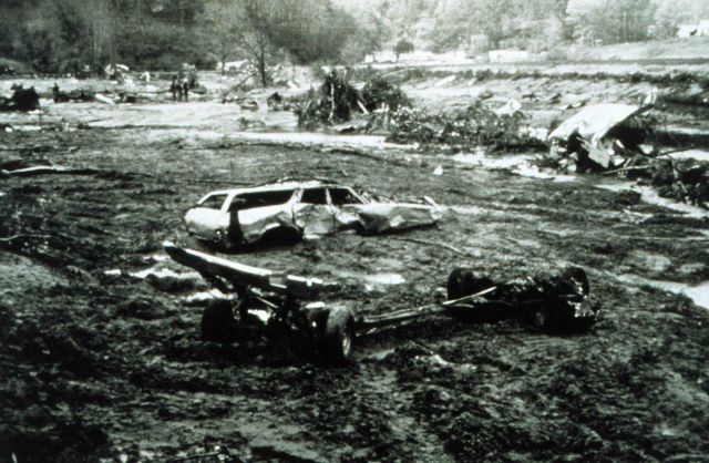 Twisted remains of a vehicle and other debris following a flash flood Picture