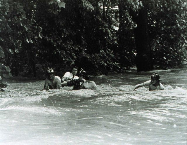 Rescuing an individual during a flash flood The strength of the current is apparent in this flash flood Note the wake patterns surrounding the rescuer Picture