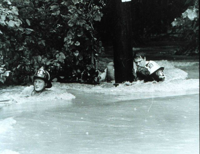 Dragging a rescued individual back to safety through the strong current The rescued man was lucky - many people have been killed by flash floods Picture