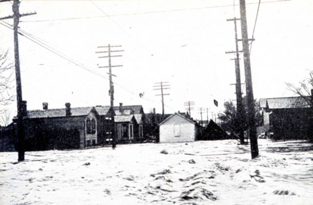 Man walking along telephone cables after escaping from house which was washed away Picture