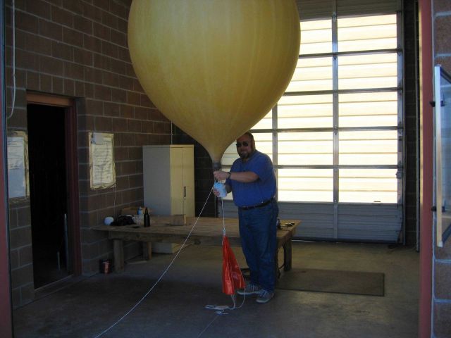 HMT Mitchell Erickson inflates a weather balloon. Picture
