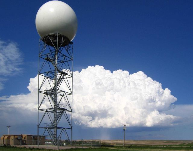 A strong supercell thunderstorm drops hail, with the WSR-88D Doppler radar at New Underwood, SD in the foreground. Picture
