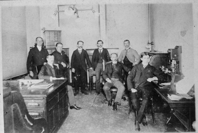 Unidentified personnel at a Weather Bureau office Picture