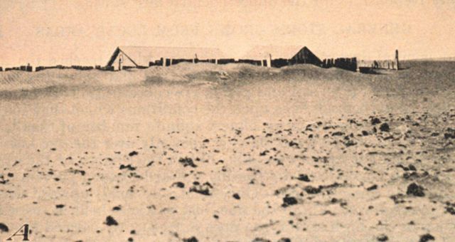 A ranch house in South Dakota saved from burial by a wooden fence Picture