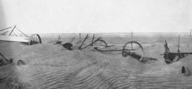 Drifting dust burying farm abandoned farm equipment Picture