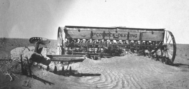 Drifting dust burying farm abandoned farm equipment Picture