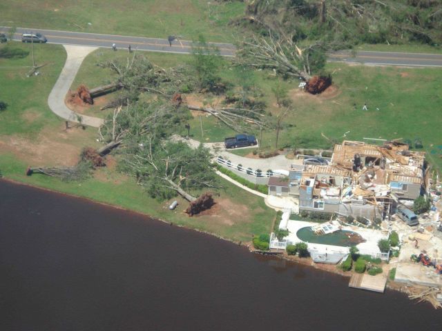 Large trees uprooted in circular pattern by Meriwether-Spalding EF3 tornado while upper roof of house in Birdie area totally blown away. Picture