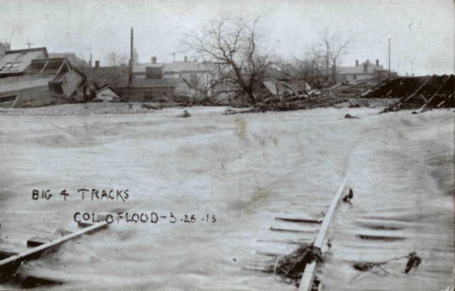 Water rushing over bent and broken railroad tracks. Picture