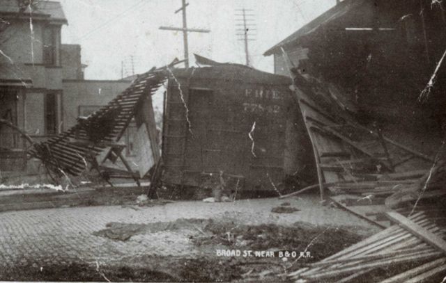 Broad Street near the B&O Railroad tracks showing box car on side with torn up track. Picture