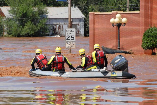 Rescue team in flooded neighborhood. Picture