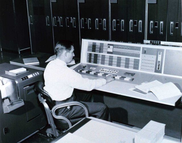 A meteorologist at the console of the IBM 7090 electronic computer in the Joint Numerical Weather Prediction Unit Picture