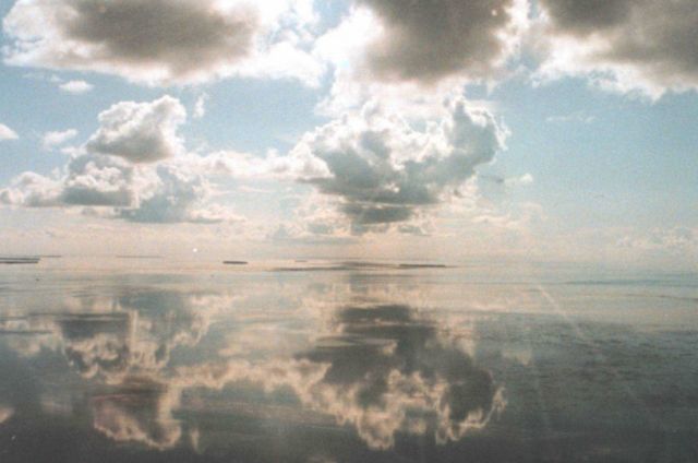 Which way is up? A mirror-smooth sea reflects cumulus clouds on a still morning in the Keys. Picture