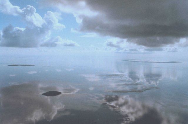 Reflections on a mirror-smooth sea make it difficult to determine where the sea begins on a horizonless morning. Picture