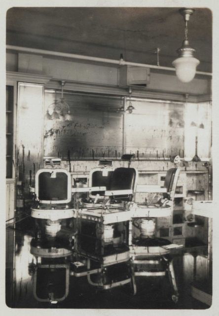 Barber shop of the Grosvenor Building with barber chairs reflected in the remnants of storm surge waters Picture
