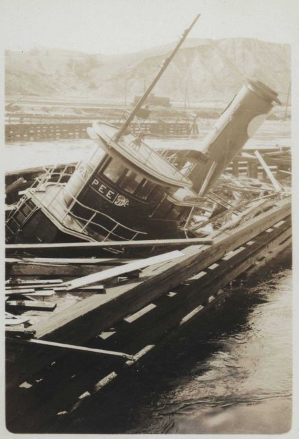 The tug GASPEE sitting on the bottom over a what appears to be the remains of a destroyed pier Picture