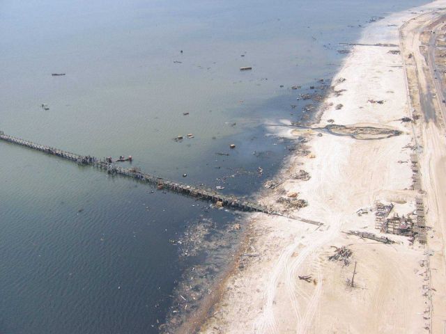 Debris from port facility strewn throughout Gulfport and ecological damage to beach. Picture