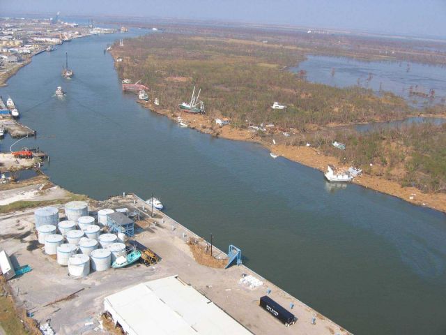 Boats on the bank with oil slicks in the water Picture