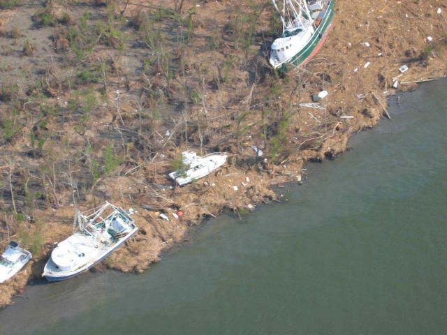 Boats on bank and oil slicks in the water at Venice. Picture