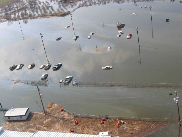 Not boats but cars in a parking lot turned pond making their own oil slicks. Picture