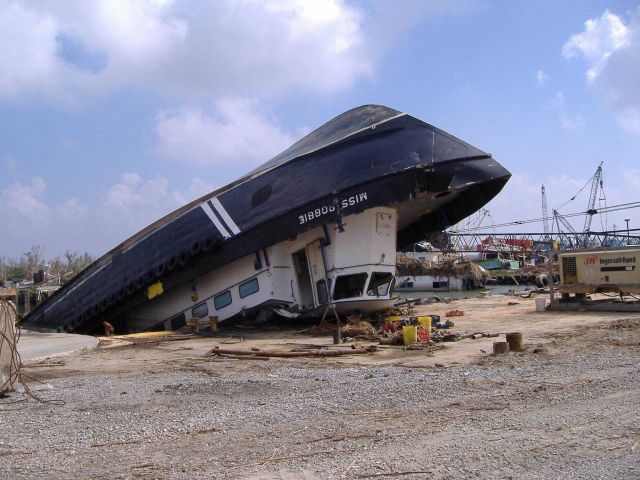 Crew boat upside down, half on and half off dock. Picture