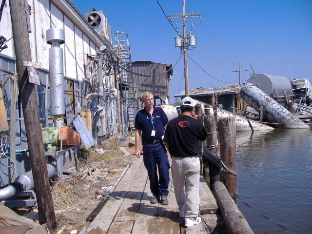 Wayne Weikel inspecting damage to fisheries infrastructure following Hurricane Katrina. Picture
