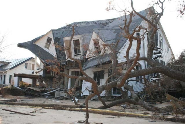 Destruction caused by Hurricane Katrina - a collapsed house, downed trees, and downed powerlines. Picture