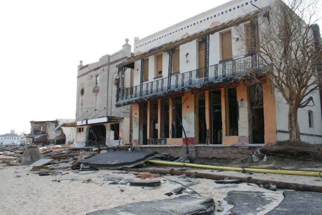 Upper floor of two adjacent buildings appear unscathed although bottom level appears to be hollow shell Picture