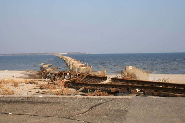 Twisted railroad track gives witness to the power of the storm surge next to destroyed railroad bridge Picture