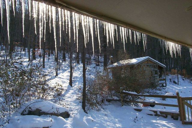Icicles on the south side of a home illuminated on a bright winter morning. Picture