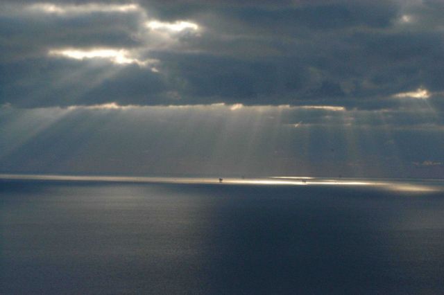 Crepuscular rays illuminate oil platforms in the Gulf of Mexico. Picture