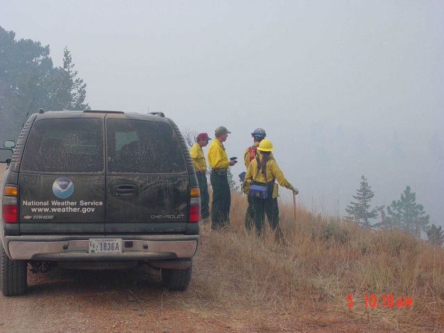 Incident Meteorologist Joel Curtis (second from left) watches the Derby Fire with some local firefighters monitoring the fire. Picture